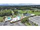 Aerial image highlights the pools, tennis courts, golf course, and other community amenities, set in a lush landscape at 3504 Wedge Way, New Port Richey, FL 34655
