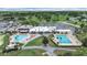 High-angle view of a refreshing community pool, golf course, and clubhouse with ample parking at 3504 Wedge Way, New Port Richey, FL 34655