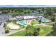 Aerial view showcasing the community pool, golf area, and clubhouse, surrounded by lush greenery at 3504 Wedge Way, New Port Richey, FL 34655