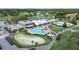 Drone shot of the community pool and golf course, near the clubhouse, perfect for recreation and relaxation at 3504 Wedge Way, New Port Richey, FL 34655
