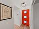 Hallway features a vibrant front door and wood flooring at 3504 Wedge Way, New Port Richey, FL 34655