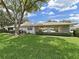 Well-maintained home exterior with attached carport and mature landscaping at 3504 Wedge Way, New Port Richey, FL 34655