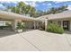 Beautiful front entrance with covered parking, mature plants, and a cozy seating area at 3504 Wedge Way, New Port Richey, FL 34655