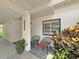 Front entrance of home with decorative potted plants and seating area at 3504 Wedge Way, New Port Richey, FL 34655