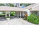 Inviting front entrance featuring a covered carport and colorful landscaping at 3504 Wedge Way, New Port Richey, FL 34655