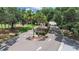Image of a gated community entrance, surrounded by mature trees, providing privacy and security at 3504 Wedge Way, New Port Richey, FL 34655