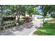 View of a quaint gatehouse entry point with lush trees lining the community entrance at 3504 Wedge Way, New Port Richey, FL 34655