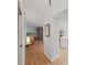 Hallway leads to a living room and kitchen with light wood-look floors at 3504 Wedge Way, New Port Richey, FL 34655