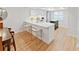 A bright kitchen that features white countertops with bar stools for seating at 3504 Wedge Way, New Port Richey, FL 34655