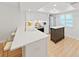 Modern kitchen with stainless steel appliances, light wood floors and custom cabinets at 3504 Wedge Way, New Port Richey, FL 34655