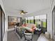 Bright screened lanai featuring ample natural light, comfortable furniture, and a view into the living room at 3504 Wedge Way, New Port Richey, FL 34655