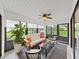 Relaxing screened-in lanai with cozy seating, a ceiling fan, and views of the outdoor landscaping at 3504 Wedge Way, New Port Richey, FL 34655