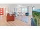 A living room with a red chair, blue couch, and colorful area rug at 3504 Wedge Way, New Port Richey, FL 34655