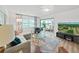 Bright living room featuring modern furniture, a ceiling fan, and sliding doors to the screened-in patio at 3504 Wedge Way, New Port Richey, FL 34655