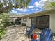 Outdoor patio with stone pavers, patio furniture, umbrella, and landscaped yard at 3504 Wedge Way, New Port Richey, FL 34655