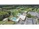 Overhead view showcases pools, tennis courts, golf course, and recreational facilities, emphasizing community offerings at 3504 Wedge Way, New Port Richey, FL 34655
