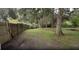 A large, open backyard with a wood fence and plenty of mature trees at 3513 Danny Bryan Blvd, Tampa, FL 33619