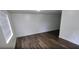 Bright living room features hardwood floors, fresh white paint, and ample natural light at 3513 Danny Bryan Blvd, Tampa, FL 33619