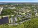 Aerial view of community featuring mature trees, water features, and well-maintained grounds at 3521 Kings Rd # 105, Palm Harbor, FL 34685