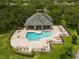 Aerial view of a community pool and spa surrounded by lounge chairs at 3521 Kings Rd # 105, Palm Harbor, FL 34685