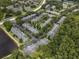 Aerial view of the community showcasing beautiful landscaping, a pond, and well-maintained buildings at 3521 Kings Rd # 105, Palm Harbor, FL 34685