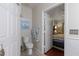 Bathroom with toilet and open bedroom door at 3521 Kings Rd # 105, Palm Harbor, FL 34685