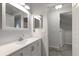 Neat bathroom with white cabinets, a mirror, and a light fixture, perfect for everyday use at 3521 Kings Rd # 105, Palm Harbor, FL 34685