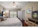 Bedroom with window, TV, and ensuite door at 3521 Kings Rd # 105, Palm Harbor, FL 34685