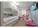 Colorful bedroom featuring a cozy bunk bed, bright pink accents, and ample play space at 3521 Kings Rd # 105, Palm Harbor, FL 34685