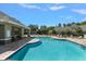 Relaxing community pool featuring lounge chairs and tables for residents at 3521 Kings Rd # 105, Palm Harbor, FL 34685