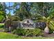 Stone Waterford Condominium Residences sign surrounded by lush landscaping and palm trees at 3521 Kings Rd # 105, Palm Harbor, FL 34685