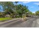 Waterford Condominium Residences entrance with lush greenery, well maintained lawns, and gated entry at 3521 Kings Rd # 105, Palm Harbor, FL 34685