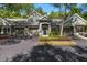Charming townhome exterior with a well-manicured lawn and a two-car garage at 3521 Kings Rd # 105, Palm Harbor, FL 34685