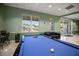 Well-lit game room with a pool table and comfortable seating at 3521 Kings Rd # 105, Palm Harbor, FL 34685