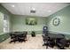 Bright game room with tile floors, ample lighting, television, dartboard, and tables with chairs at 3521 Kings Rd # 105, Palm Harbor, FL 34685