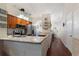 Well-equipped kitchen featuring granite countertops, stainless steel appliances, and wood cabinets at 3521 Kings Rd # 105, Palm Harbor, FL 34685