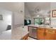 Open kitchen with stainless appliances, granite countertops, and a view into the living area at 3521 Kings Rd # 105, Palm Harbor, FL 34685