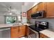 Modern kitchen with stainless steel appliances, granite counters, and ample cabinet space at 3521 Kings Rd # 105, Palm Harbor, FL 34685
