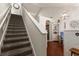 View of staircase in the house showcasing architectural design, high ceilings, and seamless access to the upper level at 3521 Kings Rd # 105, Palm Harbor, FL 34685