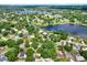 Beautiful aerial view of a neighborhood surrounded by a large lake and lush green landscaping at 3615 Greatwood Ct, Land O Lakes, FL 34639