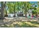 Expansive backyard with mature trees and a screened-in porch, offering a private oasis for outdoor enjoyment at 3615 Greatwood Ct, Land O Lakes, FL 34639