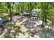 Spacious backyard with mature trees, colorful chairs, a screened patio, and a private fence at 3615 Greatwood Ct, Land O Lakes, FL 34639