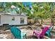 Charming backyard with colorful Adirondack chairs and a cozy fire pit area, perfect for outdoor gatherings at 3615 Greatwood Ct, Land O Lakes, FL 34639