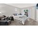 Cozy bedroom features a comfortable bed, armchair, and natural light from the window at 3615 Greatwood Ct, Land O Lakes, FL 34639