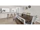 Inviting dining room with a rustic wooden table and a breakfast bar overlooking the kitchen at 3615 Greatwood Ct, Land O Lakes, FL 34639