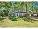 Charming single-story home featuring a well-manicured lawn, mature trees, and classic architectural design at 3615 Greatwood Ct, Land O Lakes, FL 34639