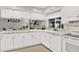 Bright kitchen with white cabinets, tile countertops, and a view to the outdoors, perfect for cooking at 3615 Greatwood Ct, Land O Lakes, FL 34639