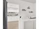 Bright laundry room featuring white cabinetry and modern appliances, providing convenience and style at 3615 Greatwood Ct, Land O Lakes, FL 34639