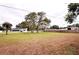 Spacious backyard with mature trees creating a shaded landscape at 38819 Otis Allen Rd, Zephyrhills, FL 33540