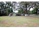 Wide view of the backyard featuring a carport and plenty of open space at 38819 Otis Allen Rd, Zephyrhills, FL 33540